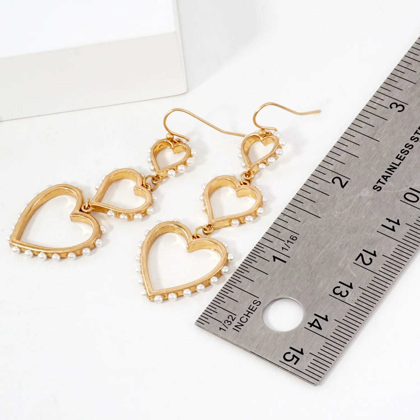Three Graduated Heart Drop Earrings With Pearl-Trimmed Edges
