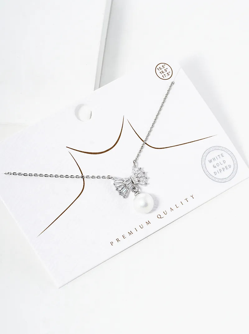 White Gold Dipped Baguette CZ Ribbon Bow With Glass Pearl Drop Pendant Necklace
