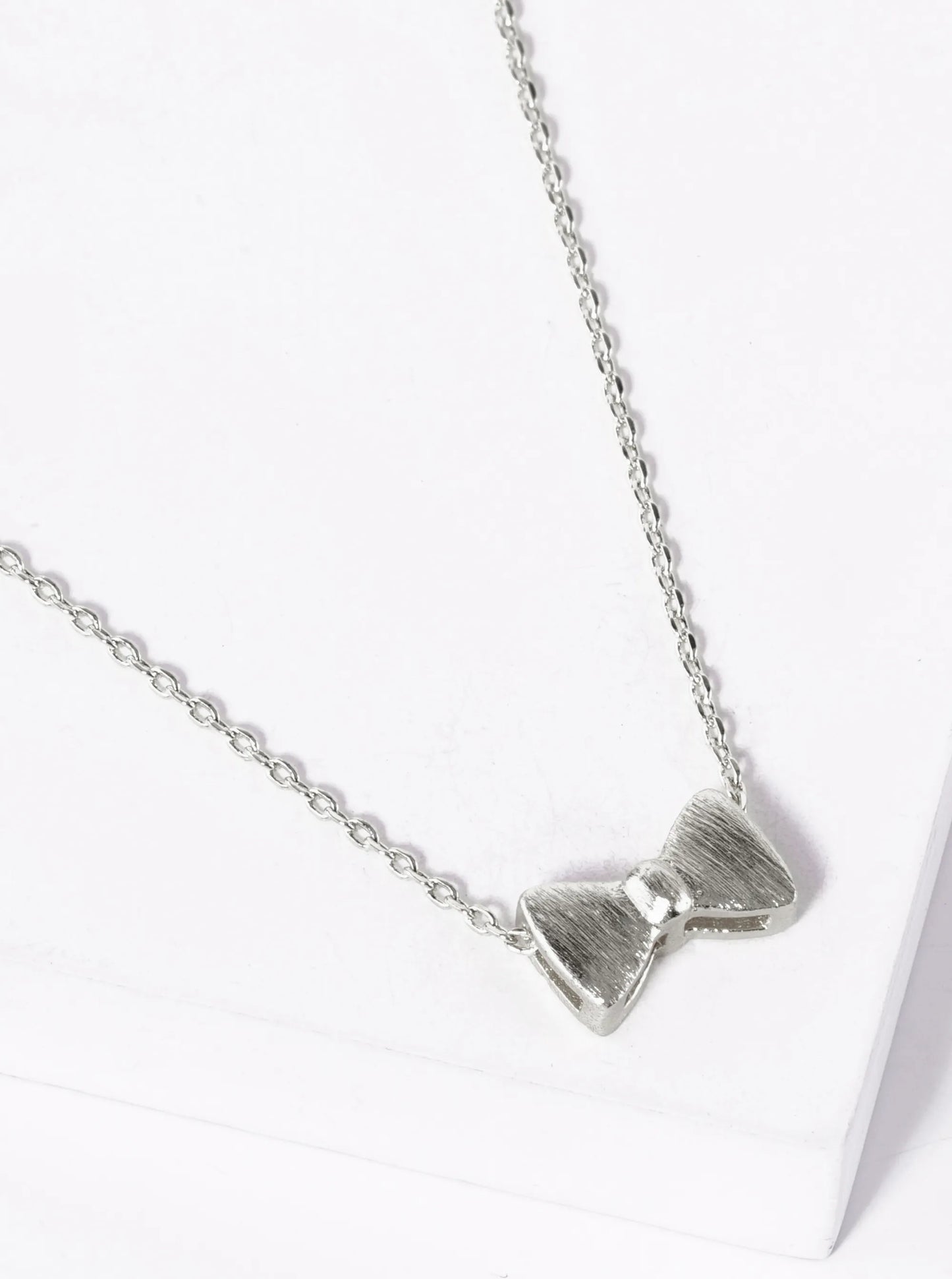 White Gold Dipped Brushed Metal Ribbon Bow Pendant Necklace