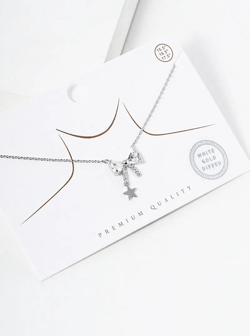 White Gold Dipped CZ Pave Ribbon Bow With Star Drop Pendant Necklace
