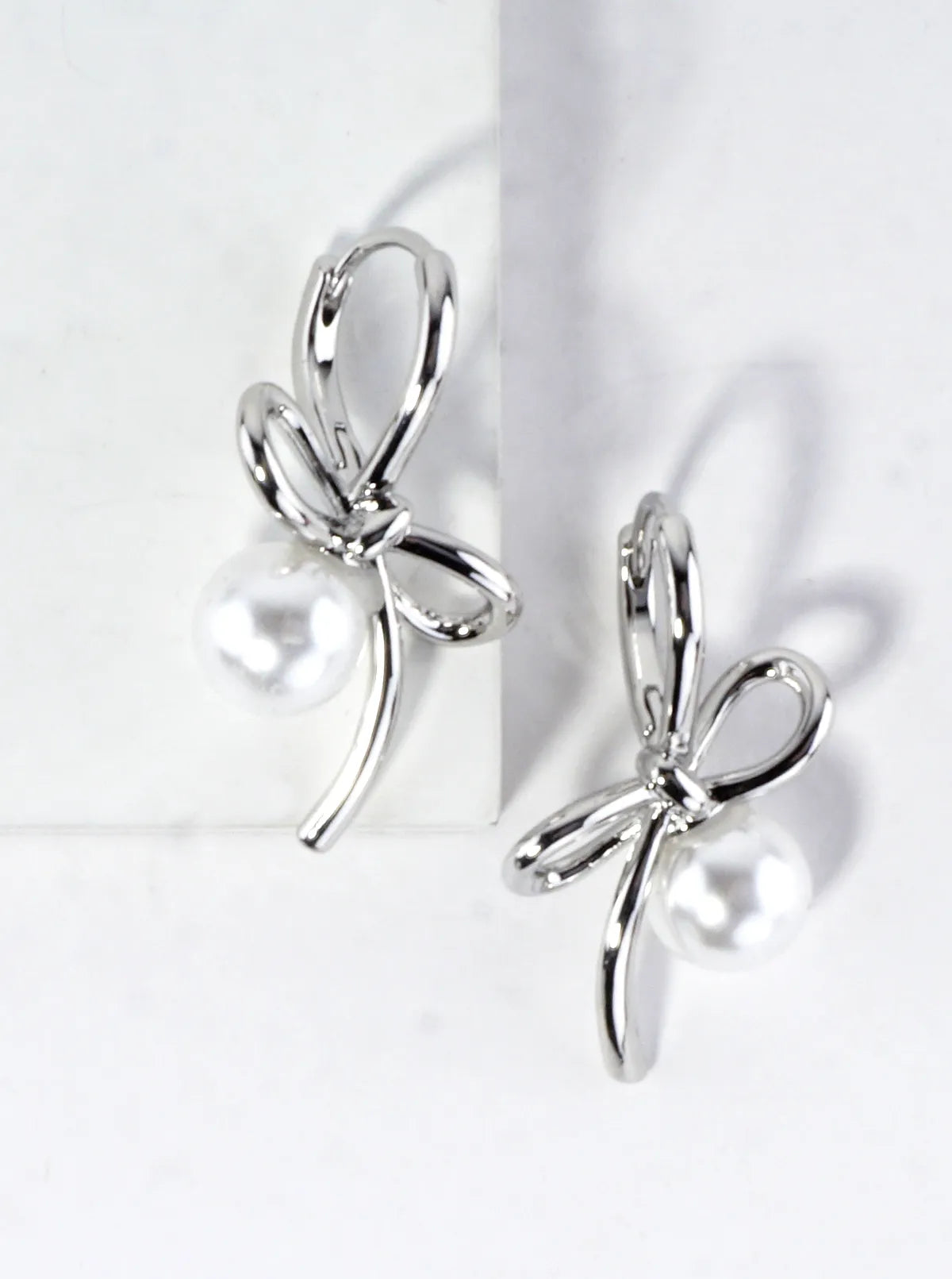 Brass Bow On Pearl Pedestal Drop Earrings