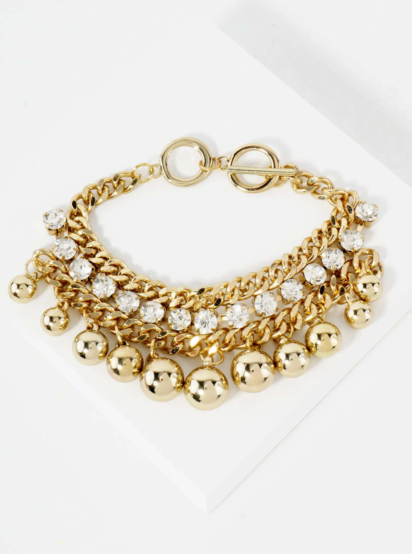 Polished Metal Toggle Bracelet With 4-Prong Rhinestone Accents Graduated Metallic Ball Charms
