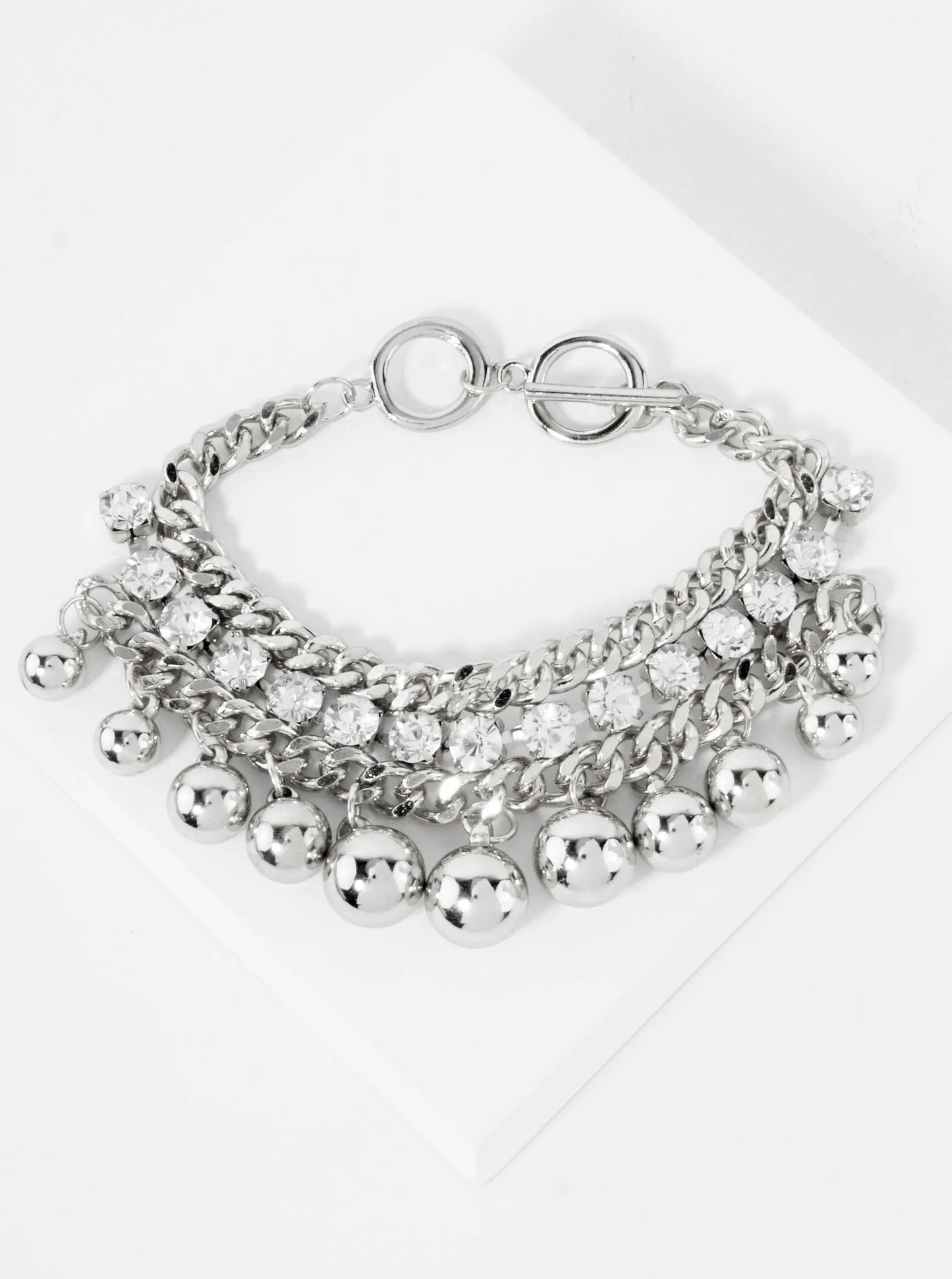 Polished Metal Toggle Bracelet With 4-Prong Rhinestone Accents Graduated Metallic Ball Charms