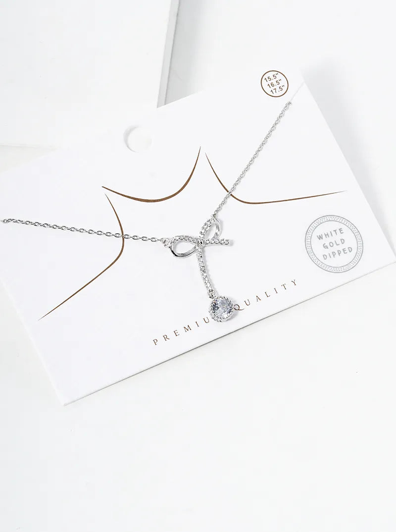 White Gold Dipped CZ Pave Ribbon Bow With Star Drop Pendant Necklace